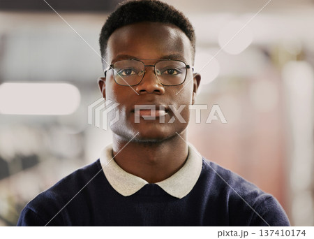Student, university and portrait of black man on campus for learning, education and vision for future career. Face of African person in library with glasses for research, school project and studying 137410174