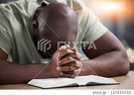 Bible, hands and praying man with book and religion study at home for worship and spiritual support. Faith, christian knowledge and person with gratitude, scripture education and guidance in a house 137410338
