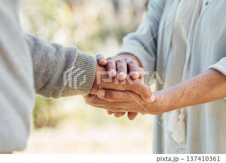 Senior couple, holding hands and love with support in outdoor, nature or bonding in backyard with care, comfort or kindness. Helping, hand and people in retirement together with empathy and trust 137410361