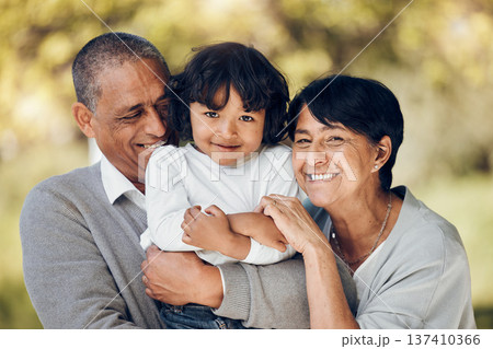 Family, portrait and hug by child and grandparents in a park with care, bond and fun on blurred background. Love, smile and face of senior people embrace retirement freedom with kid in a forest Family, portrait and hug by child and grandparents in a park with care, bond and fun on blurred background. Love, smile and face of senior people embrace retirement freedom with kid in a forest 137410366