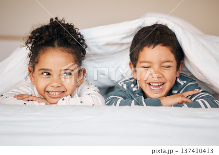 Siblings, morning and face of children in bed in blanket for bonding, love and fun together at home. Family, childhood and happy young boy and girl smile in bedroom for relaxing, resting and laying Siblings, morning and face of children in bed in blanket for bonding, love and fun together at home. Family, childhood and happy young boy and girl smile in bedroom for relaxing, resting and laying 137410413