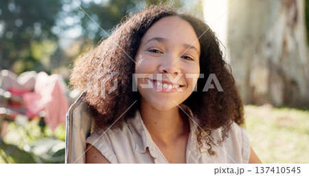 Nature, face of happy woman in chair and camping in forest for vacation, adventure and freedom. Relax at camp, smile and girl sitting in woods with trees, grass and happiness on eco friendly holiday. Nature, face of happy woman in chair and camping in forest for vacation, adventure and freedom. Relax at camp, smile and girl sitting in woods with trees, grass and happiness on eco friendly holiday. 137410545