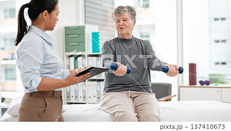 Physiotherapy tablet, senior woman and dumbbell for muscle, fitness and stretching support on digital checklist. Physical therapy, medical or chiropractor person helping elderly patient with exercise Physiotherapy tablet, senior woman and dumbbell for muscle, fitness and stretching support on digital checklist. Physical therapy, medical or chiropractor person helping elderly patient with exercise 137410673