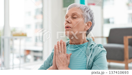 Yoga, namaste meditation and woman breathing for mindfulness, senior exercise or healing at home. Face of healthy old lady, breathe and meditate with prayer hands for zen, wellness and focus on peace Yoga, namaste meditation and woman breathing for mindfulness, senior exercise or healing at home. Face of healthy old lady, breathe and meditate with prayer hands for zen, wellness and focus on peace 137410693