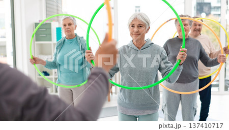 Fitness, senior and people with hula hoop at the gym for training, workout and health in retirement. Happy, together and a group of elderly friends with a coach and gear for an exercise class Fitness, senior and people with hula hoop at the gym for training, workout and health in retirement. Happy, together and a group of elderly friends with a coach and gear for an exercise class 137410717