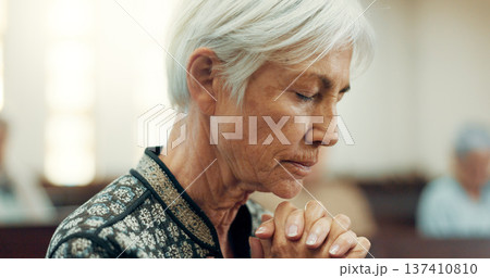 Senior, prayer or old woman in church for God, holy spirit or religion in cathedral or Christian community. Faith, spiritual or face of elderly person in chapel or sanctuary to praise Jesus Christ 137410810