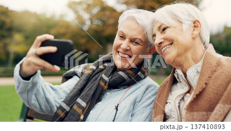 Senior, women and selfie in a park happy, bond and relax in nature on a bench together. Friends, old people and ladies smile for social media, profile picture or memory in forest chilling on weekend Senior, women and selfie in a park happy, bond and relax in nature on a bench together. Friends, old people and ladies smile for social media, profile picture or memory in forest chilling on weekend 137410893