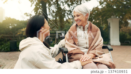 Wheelchair, park and a senior woman with a disability talking to her nurse during a walk together outdoor. Healthcare, medical and a female care chatting to an elderly patient or resident in a garden Wheelchair, park and a senior woman with a disability talking to her nurse during a walk together outdoor. Healthcare, medical and a female care chatting to an elderly patient or resident in a garden 137410931
