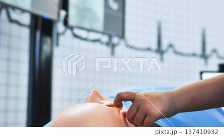 Healthcare student learning CPR and clinical procedures using a medical simulation dummy Healthcare student learning CPR and clinical procedures using a medical simulation dummy 137410932