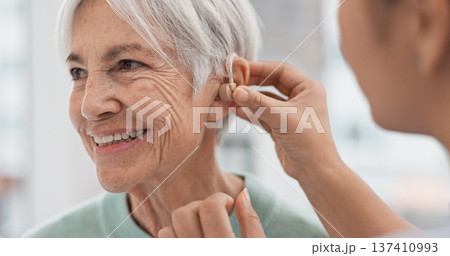Old woman, doctor hands and patient with hearing aid, help and support with healthcare in clinic. Person with disability, deaf and people, trust and communication, health insurance and medical Old woman, doctor hands and patient with hearing aid, help and support with healthcare in clinic. Person with disability, deaf and people, trust and communication, health insurance and medical 137410993