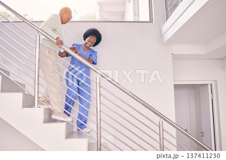 Nurse, help and walking with old woman on stairs for medical, support and life insurance. Retirement, healthcare and medicine with senior patient and caregiver in nursing home for wellness and safety 137411230