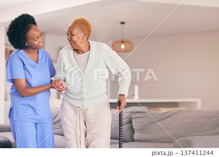 Nurse, holding hands and senior black woman with walking stick, help or smile in home. Caregiver, support and elderly patient with a disability, cane and kindness in assistance, empathy or healthcare Nurse, holding hands and senior black woman with walking stick, help or smile in home. Caregiver, support and elderly patient with a disability, cane and kindness in assistance, empathy or healthcare 137411244
