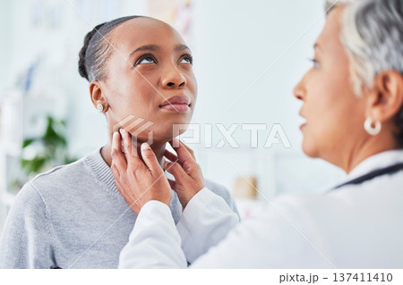 Sore throat, doctor and woman patient in hospital for virus, pain or infection. Healthcare worker and sick African person check neck for thyroid exam or respiratory care at medical consultation Sore throat, doctor and woman patient in hospital for virus, pain or infection. Healthcare worker and sick African person check neck for thyroid exam or respiratory care at medical consultation 137411410