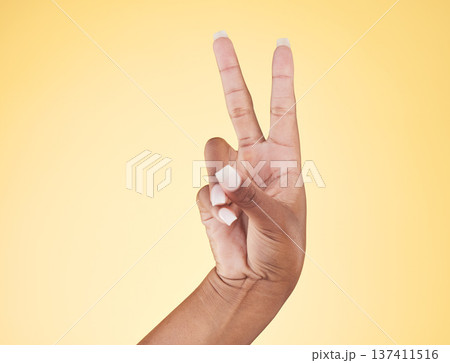 Closeup, hands and peace sign with emoji, support and voice on a yellow studio background. Hand of female, person and model showing v symbol, icon or shape for hope, trust in vote and mockup space Closeup, hands and peace sign with emoji, support and voice on a yellow studio background. Hand of female, person and model showing v symbol, icon or shape for hope, trust in vote and mockup space 137411516