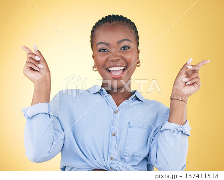 Portrait, dance and celebration with an excited black woman on a yellow background in studio looking happy. Smile, energy or surprise and a young person cheering for success or bonus with motivation 137411518
