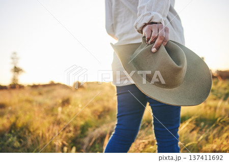 Farm, agriculture and woman with hat in field on holiday, vacation and travel in countryside. Walk, morning and hands of person with freedom in nature for sustainable farming, growth and environment 137411692