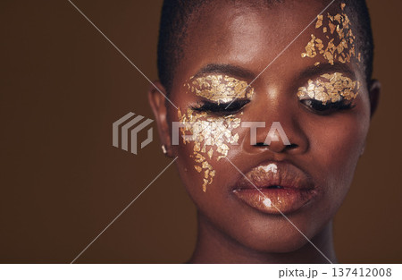 Gold, face and black woman with makeup for beauty aesthetics isolated in a studio brown background eyes closed. Creative, luxury and African person with cosmetic glamour, art or design for skincare 137412008
