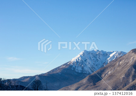 View of the mountains from Rosa Khutor, Krasnaya Polyana in winter. Snow-covered mountains against a blue sky. 137412016