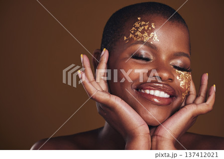 Gold beauty, makeup and woman face closeup with a smile from luxury treatment and facial spa mask. Glitter art, golden dermatology and African person with creative and sparkle cosmetics in studio Gold beauty, makeup and woman face closeup with a smile from luxury treatment and facial spa mask. Glitter art, golden dermatology and African person with creative and sparkle cosmetics in studio 137412021