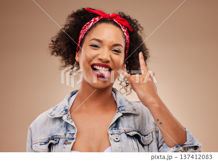Woman, horns sign and studio portrait with tongue, comic smile and funny face with beauty by brown background. African girl, model or student with icon, crazy and rock star hand with laugh for beauty 137412083