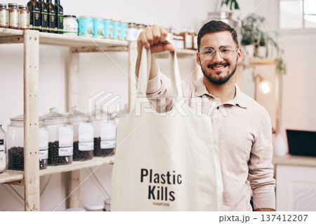 Man at eco friendly grocery store, recycling shopping bag and commitment to climate change at sustainable small business. Zero waste, plastic kills logo and supermarket with carbon footprint choice. 137412207