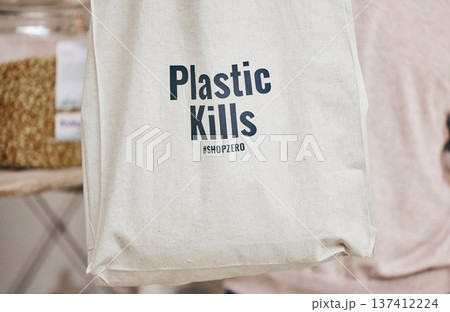 Eco friendly grocery store, recycling fabric shopping bag and commitment to climate change at sustainable small business. Zero waste, plastic kills logo and supermarket with carbon footprint choice. 137412224