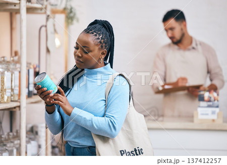 Shopping, grocery store and black woman by shelf for choice, options and service in eco friendly supermarket. Small business, organic shop and customer reading label for groceries, products and food 137412257