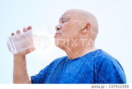 Senior man, drinking water and fitness outdoor, healthy body and h2o liquid for wellness nutrition. Elderly man, bottle and hydration after exercise, cardio workout or training in running sports. 137412309