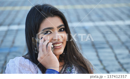 Young Indian woman talking on phone in Moscow 137412357