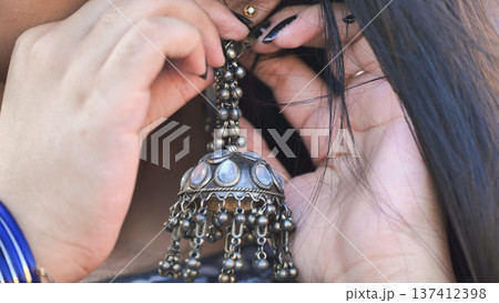 Indian woman wearing traditional jhumka earrings and bangles Indian woman wearing traditional jhumka earrings and bangles 137412398