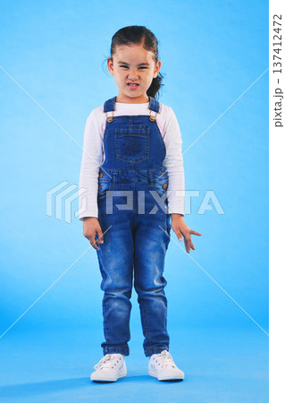 Angry, attitude and portrait of child on blue background with upset, mad and frustrated facial expression. Behaviour, youth and young girl with body language for anger, tantrum and emotion in studio Angry, attitude and portrait of child on blue background with upset, mad and frustrated facial expression. Behaviour, youth and young girl with body language for anger, tantrum and emotion in studio 137412472