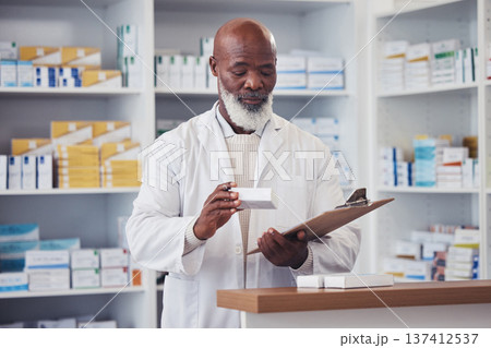 Pharmacy medicine, clipboard and mature black man reading product description, package info or checklist for clinic inventory. List, medical pills box and pharmacist check pharmaceutical supplements Pharmacy medicine, clipboard and mature black man reading product description, package info or checklist for clinic inventory. List, medical pills box and pharmacist check pharmaceutical supplements 137412537