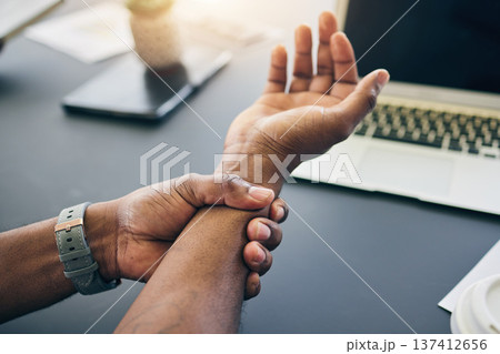 Closeup of a businessman with wrist injury, pain or accident in the office with carpal tunnel. Medical emergency, arthritis and male person with nerve, muscle or joint sprain in his arm in workplace. Closeup of a businessman with wrist injury, pain or accident in the office with carpal tunnel. Medical emergency, arthritis and male person with nerve, muscle or joint sprain in his arm in workplace. 137412656