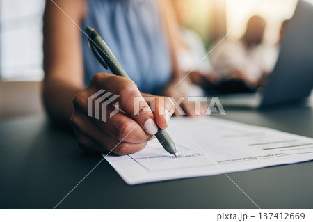 Closeup, hand and a person with a document for accounting, finance paperwork or business. Desk, office and an accountant or employee writing on a report or agreement for a salary or work income 137412669