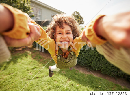 Kid, spin and outdoor in pov, holding hands and happy for game with parent, holiday or backyard. Excited young child, smile and swing in air, fast and grass for play on vacation, sunshine or portrait 137412838