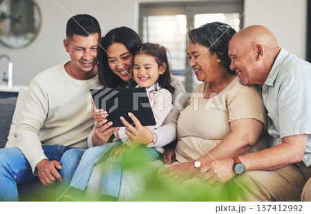 Tablet, family and children on a sofa in the living room together during a visit with grandparents in retirement. Parents, senior people and kids using technology while browsing social media or games Tablet, family and children on a sofa in the living room together during a visit with grandparents in retirement. Parents, senior people and kids using technology while browsing social media or games 137412992