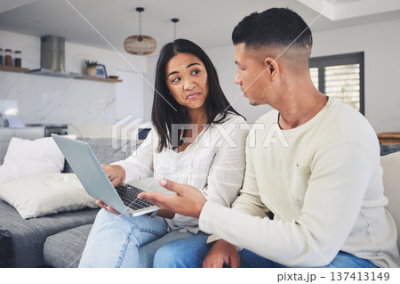 Couple, laptop and decision, doubt on sofa for online shopping or business idea in living room or home. Computer, man and woman with choice on internet for financial planning with tech subscription Couple, laptop and decision, doubt on sofa for online shopping or business idea in living room or home. Computer, man and woman with choice on internet for financial planning with tech subscription 137413149