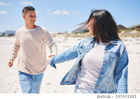 Love, smile and holding hands with couple at beach for travel, summer vacation and romance together. Happy, relax and bonding with man and woman walking on seaside holiday for care, date or honeymoon Love, smile and holding hands with couple at beach for travel, summer vacation and romance together. Happy, relax and bonding with man and woman walking on seaside holiday for care, date or honeymoon 137413163