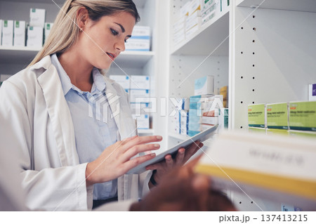 Tablet, clinic woman and pharmacist reading, typing and search hospital database for product, pills or medicine. Pharmacy shop, online research and health expert check pharmaceutical supplements info Tablet, clinic woman and pharmacist reading, typing and search hospital database for product, pills or medicine. Pharmacy shop, online research and health expert check pharmaceutical supplements info 137413215