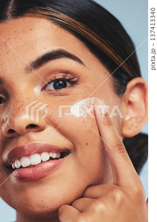 Face, skincare cream and portrait of woman for aesthetic shine, dermatology and makeup cosmetics on studio background. Closeup, happy model and facial sunscreen lotion for self care, beauty and glow Face, skincare cream and portrait of woman for aesthetic shine, dermatology and makeup cosmetics on studio background. Closeup, happy model and facial sunscreen lotion for self care, beauty and glow 137413340