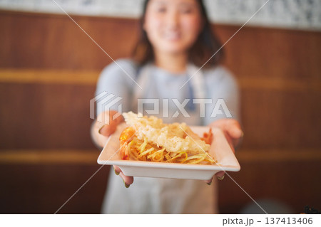Hands, waitress and woman with seafood on plate, shrimp and tempura for eating at restaurant, cafe or store. Fish, food and person in sushi service, prawn and meat in fine dining, brunch and chips Hands, waitress and woman with seafood on plate, shrimp and tempura for eating at restaurant, cafe or store. Fish, food and person in sushi service, prawn and meat in fine dining, brunch and chips 137413406