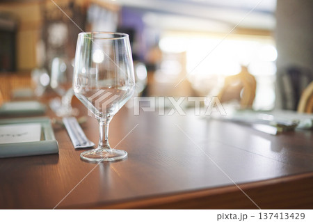 Bokeh, lunch and glass on a table at a restaurant for water, alcohol or wine. Dinner, crystal and tableware for a drink at a coffee shop or cafe during dinner for a luxury and fine dining experience Bokeh, lunch and glass on a table at a restaurant for water, alcohol or wine. Dinner, crystal and tableware for a drink at a coffee shop or cafe during dinner for a luxury and fine dining experience 137413429