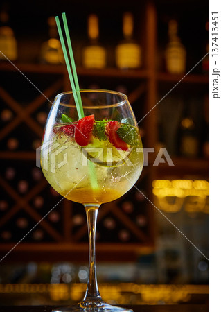 A multi-sensory cocktail featuring vibrant strawberries, lime, and mint in a chilled wine glass. A multi-sensory cocktail featuring vibrant strawberries, lime, and mint in a chilled wine glass. 137413451