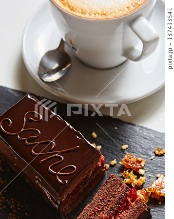 Vibrant sliced Sachertorte cake with rich chocolate ganache and apricot layers 137413541