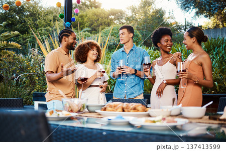 Talk, friends at dinner in garden at party and celebration with diversity, food and wine at outdoor event. Conversation, men and women at table for lunch, fun people with drinks in backyard together. 137413599
