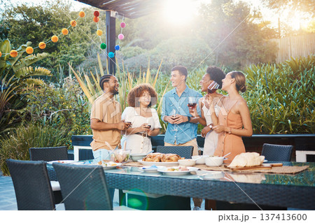 Conversation, group of friends at dinner in garden at party and celebration with diversity, food and wine at outdoor lunch. Chat, men and women at table, fun people with drinks in backyard together. 137413600