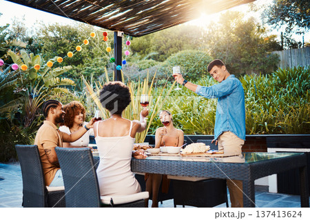 Cheers, group of friends at dinner in garden at party and celebration with diversity, food and wine at outdoor party. Glass toast, men and women at table, fun people with drinks in backyard together. Cheers, group of friends at dinner in garden at party and celebration with diversity, food and wine at outdoor party. Glass toast, men and women at table, fun people with drinks in backyard together. 137413624