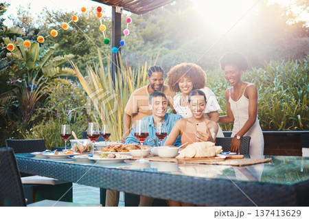 Selfie, group of friends at dinner in garden and happy event with diversity, food and wine at outdoor party. Photography, men and women at table, fun people with drinks in backyard at sunset together Selfie, group of friends at dinner in garden and happy event with diversity, food and wine at outdoor party. Photography, men and women at table, fun people with drinks in backyard at sunset together 137413629