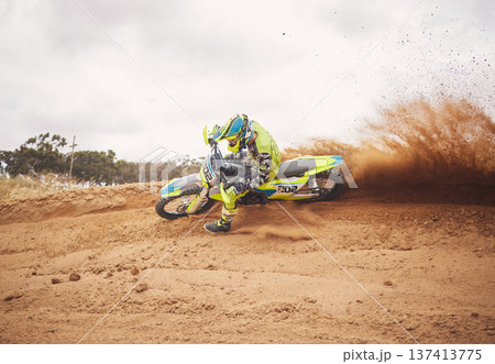 Desert, dirt and motorbike cycling for sports, agile driving and off road adventure with speed, power and mockup space on cloudy sky. Motorcycle, rally challenge and driver in fast race on sand dunes 137413775