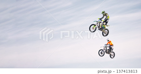 Sky, jump and men on motorbike together for practice, training and extreme sports energy in mockup. Professional dirt biking challenge, friends in air and danger with off road motorcycle competition. Sky, jump and men on motorbike together for practice, training and extreme sports energy in mockup. Professional dirt biking challenge, friends in air and danger with off road motorcycle competition. 137413813